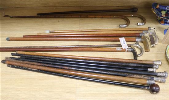 A collection of walking sticks, many silver mounted